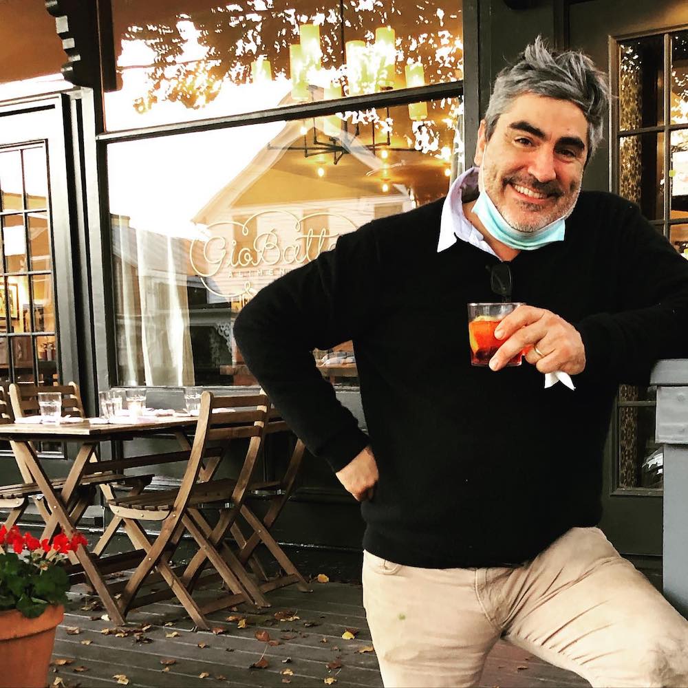 Chef Francesco Buitoni posing for a photo in front of his restaurant Giobatta Alimentari
