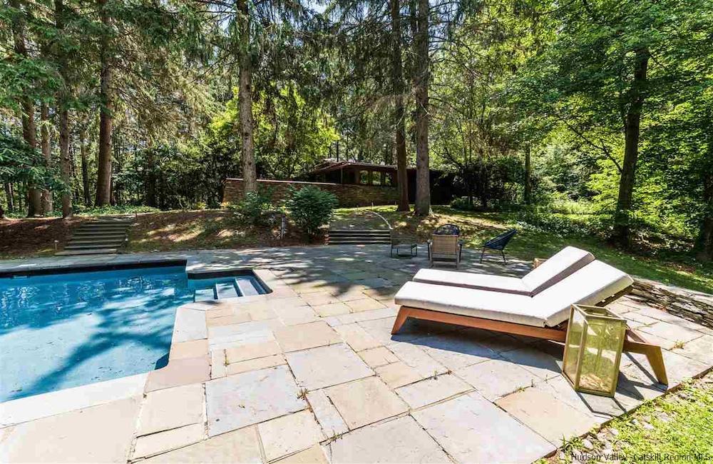 close-up of pool with two lounge chairs