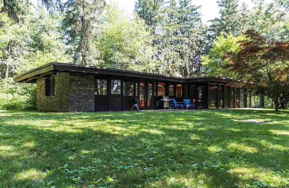 photo of a brown house in the woods