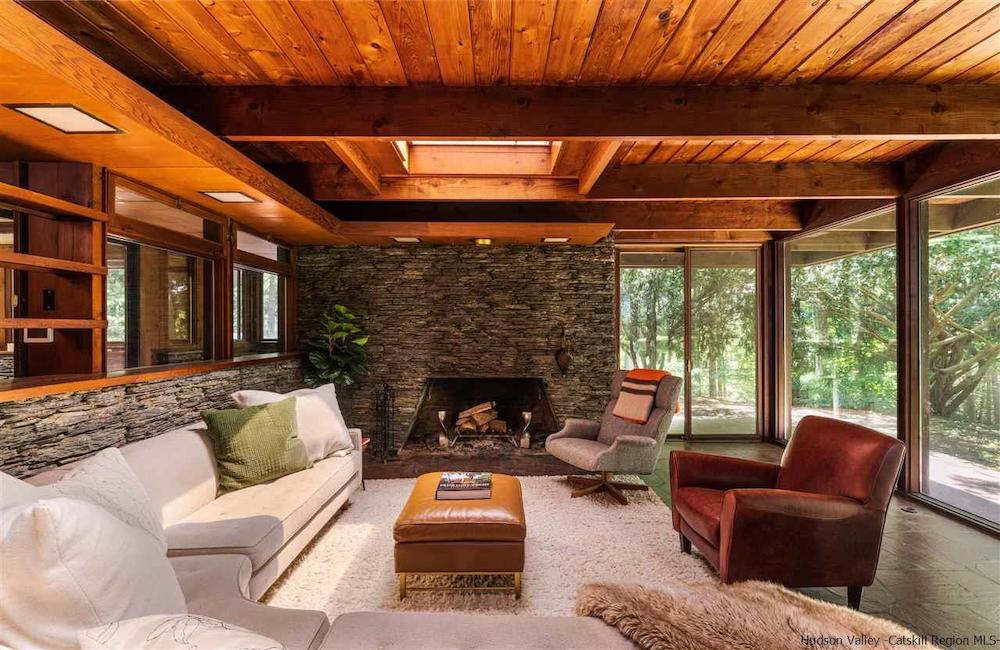 Mid-century home | living room with white couche and fireplace