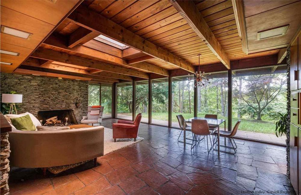living and dining room facing the glass wall with views