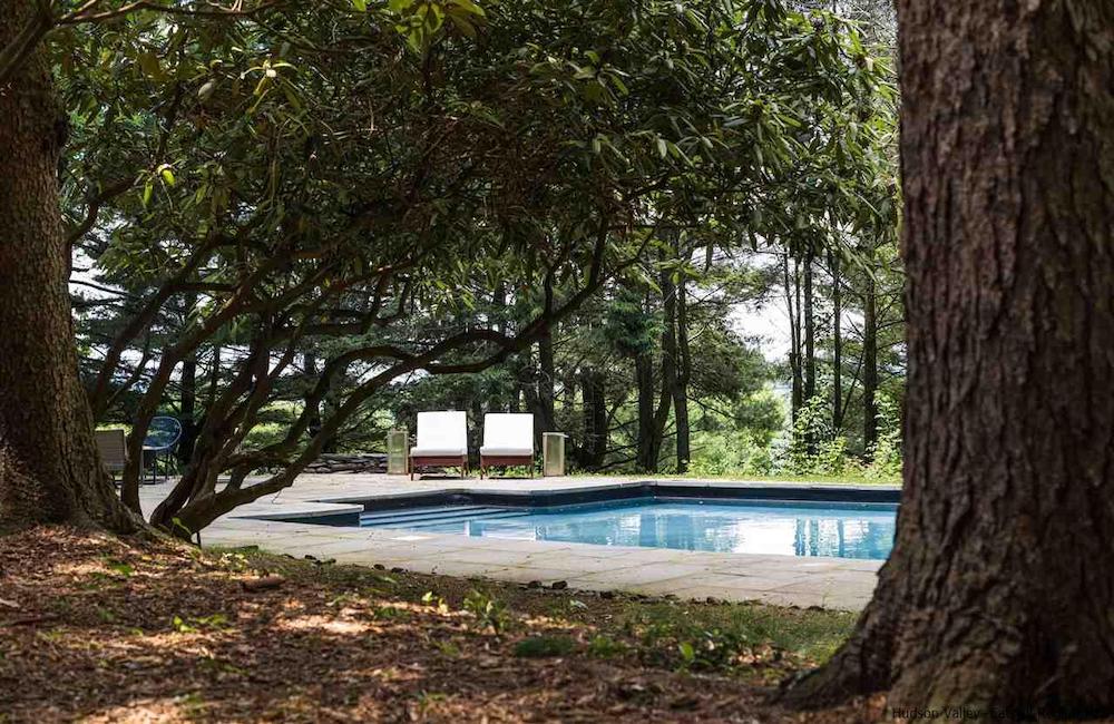 outdoor pool and two lounge chairs