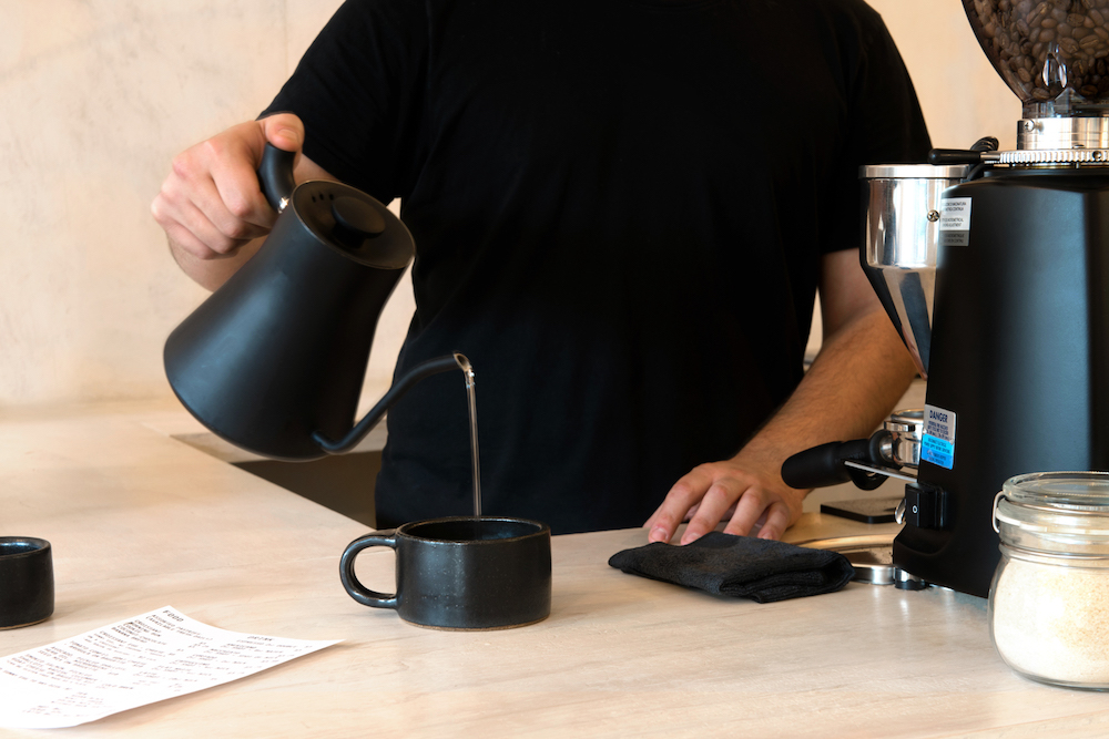 barista pouring coffee