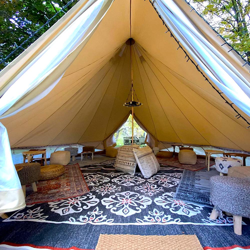 glamping tent with pillows, cushions and rugs
