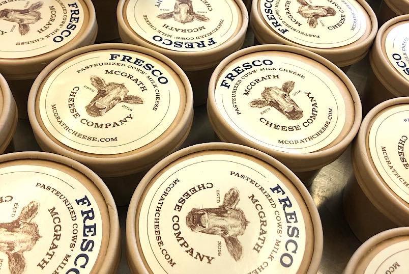a bunch of different cheese container's tops