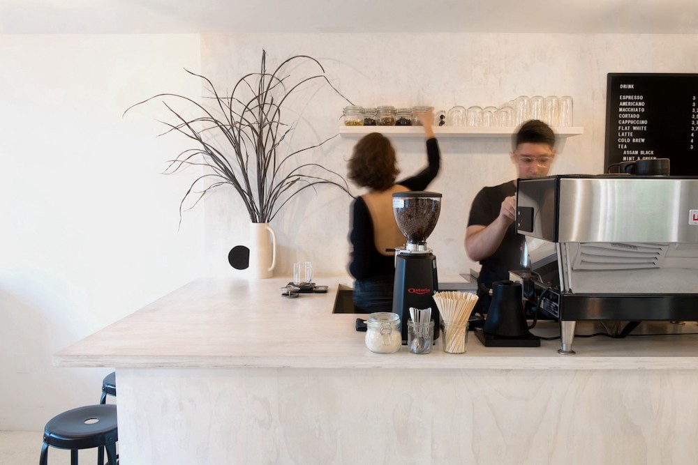 baristas making coffee in a cafe
