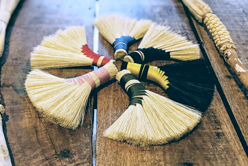 handmade short brooms in a circle
