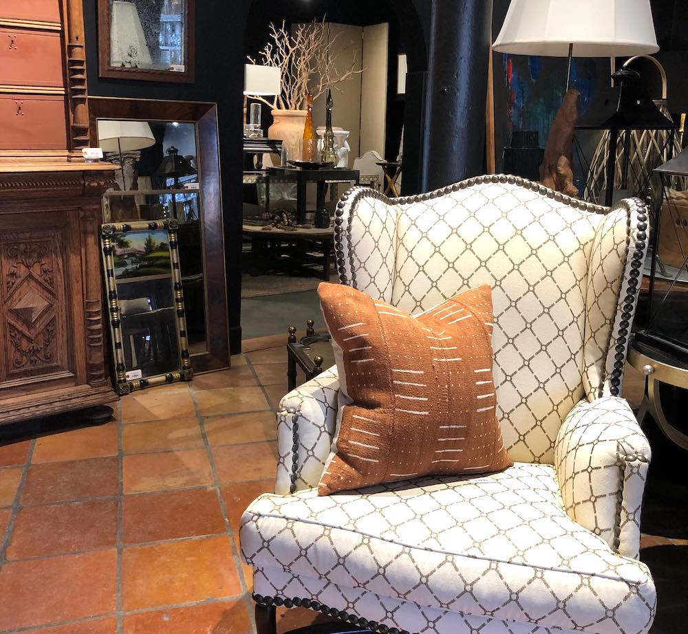 white couch chair with pillow and lamp
