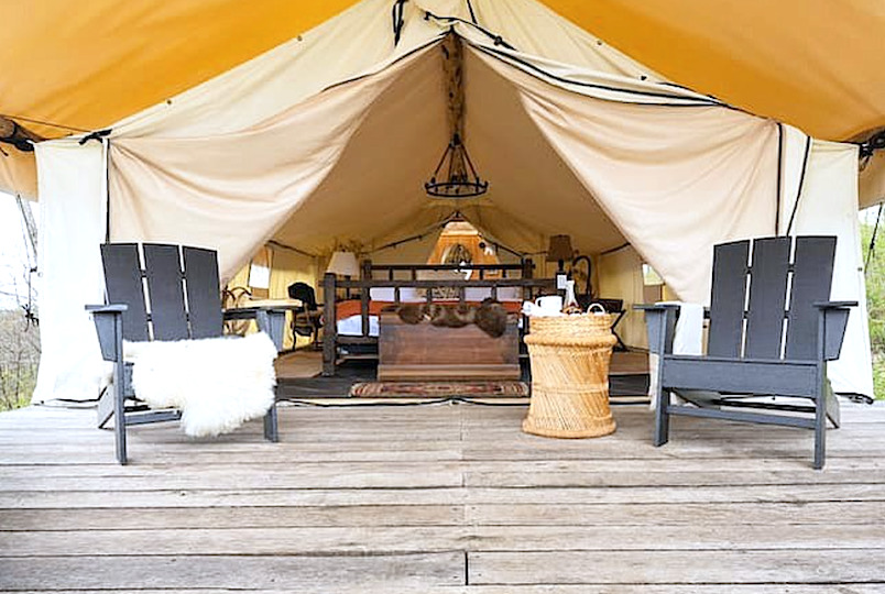 glamping tent and two chairs on a deck