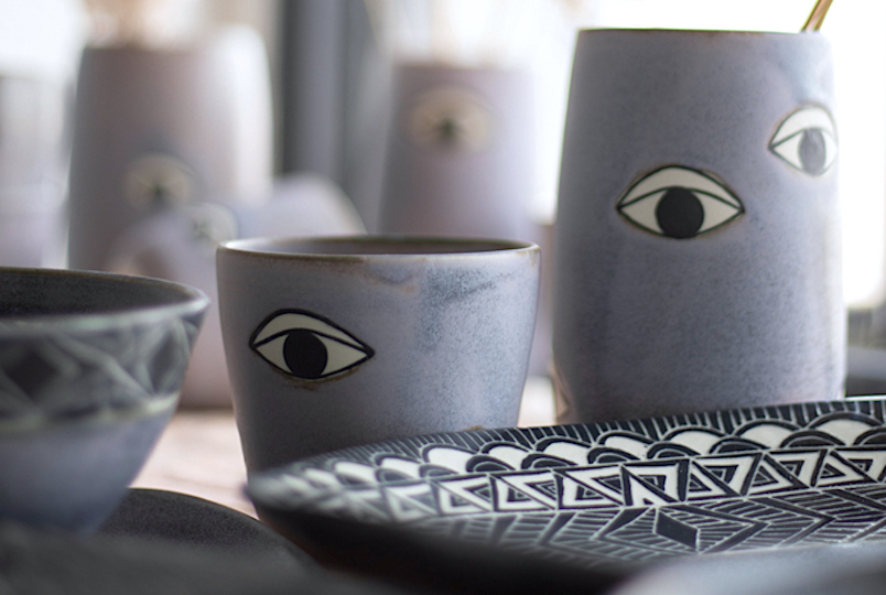 group of ceramics with eyes painted on them