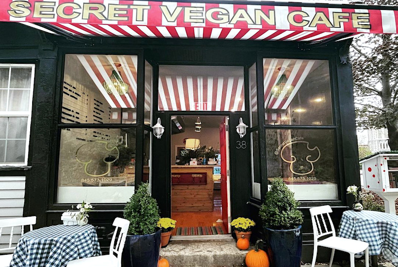 storefront with chairs and tables and door open