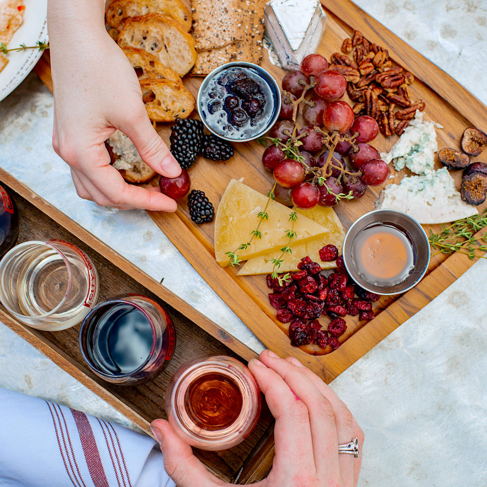 cheese board with multiple wines for tasting
