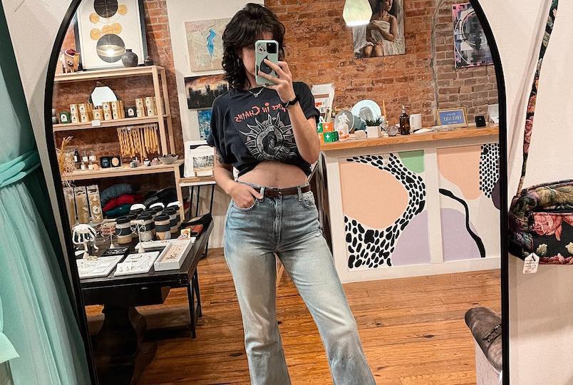 woman in front of mirror taking a selfie