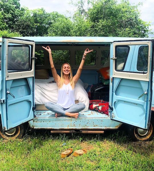 woman sitting in an old van