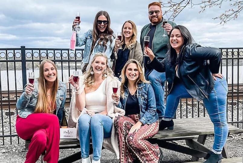 group of friends with wine posing for a picture
