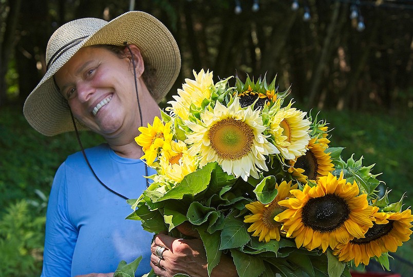Adele with bouquet of Sunflowers at her Feather Hill Flower Farm in Valatie NY.