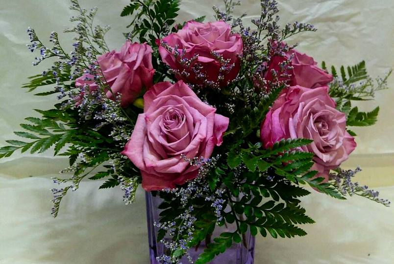Beautiful bouquet of pink roses in a purple vase from Brown's Florist in Kingston NY