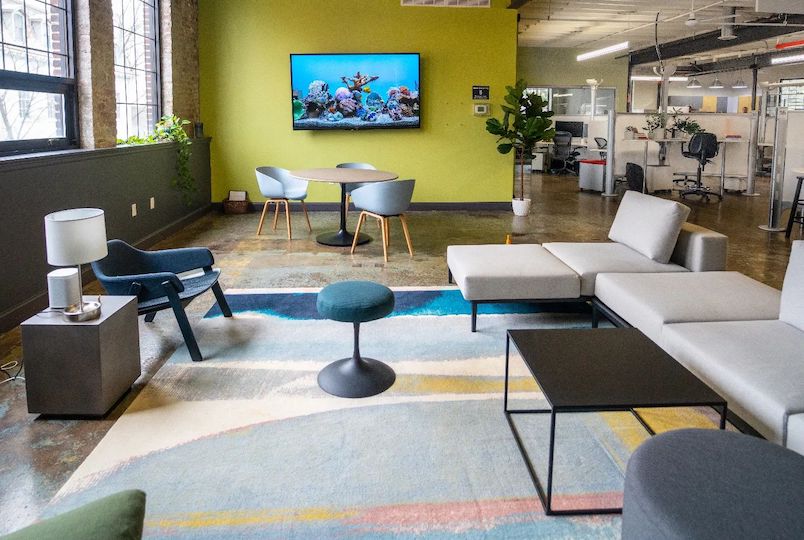 An office space with chairs and couches at the Cowork Kingston