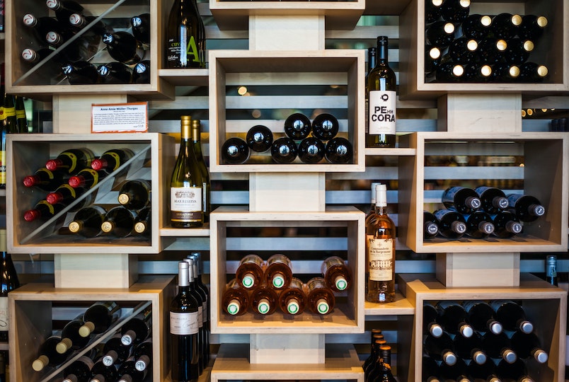 bottles of wine on a rack in a store