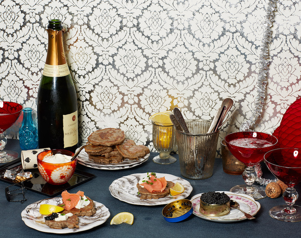 various foods and bottle of champagne styled by Food Stylist Liza Jernow in Kerhonkson, NY