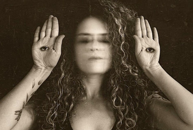 Artsy photograph of Anna Sirota with two eyes in the palms of her hands by Anna Sirota Photography in Beacon NY