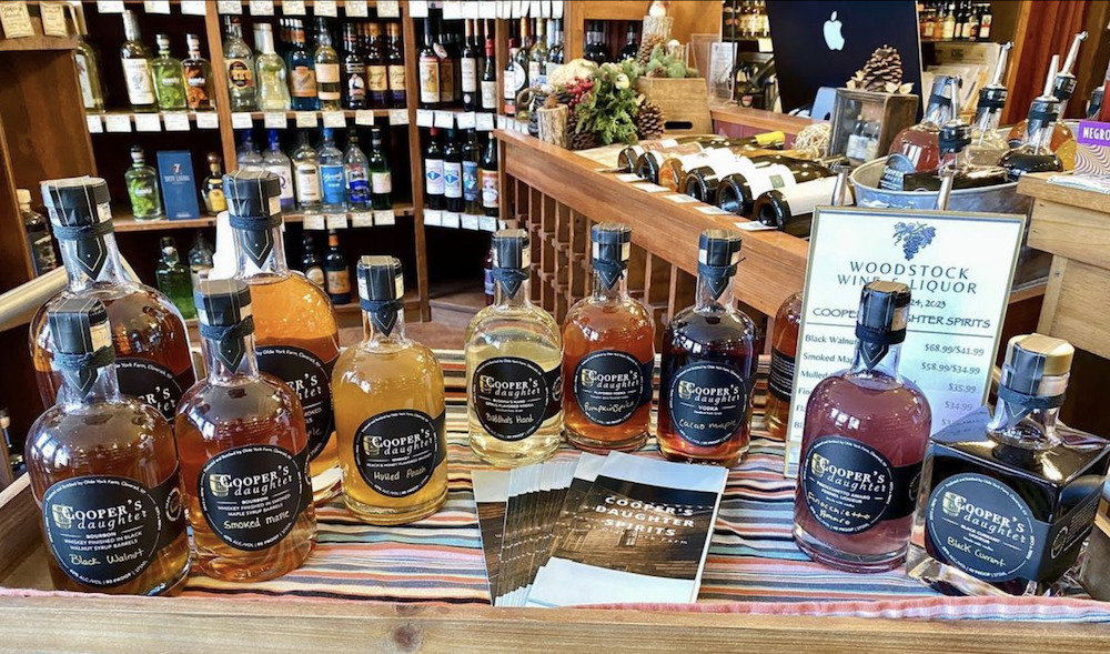 a bunch of spirits displayed on a counter for tasting at Woodstock Wine & Liquors in Woodstock, NY