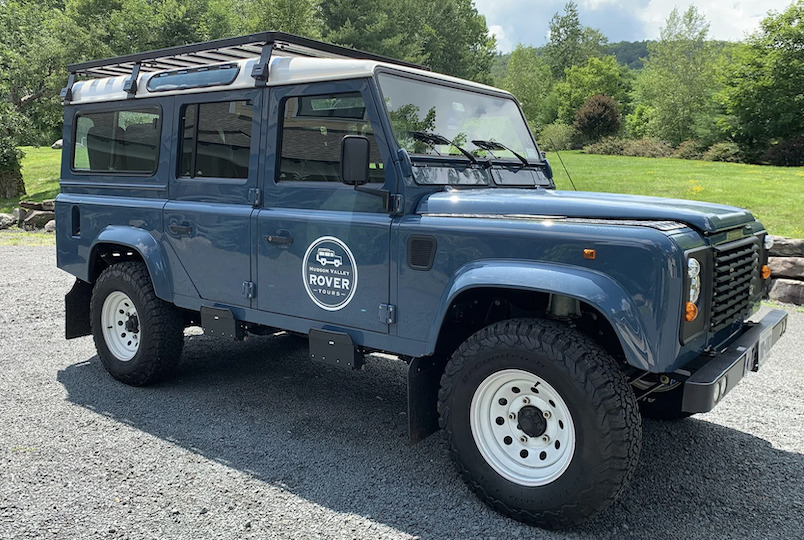 Picture of a Blue Rover Jeep with business sign on the side for Hudson Valley Rover Tours in Leeds NY