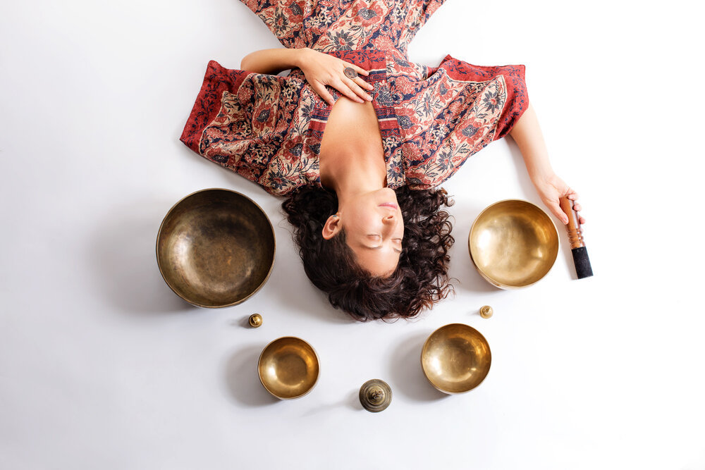 Jessica Caplan with sound bowls around her head