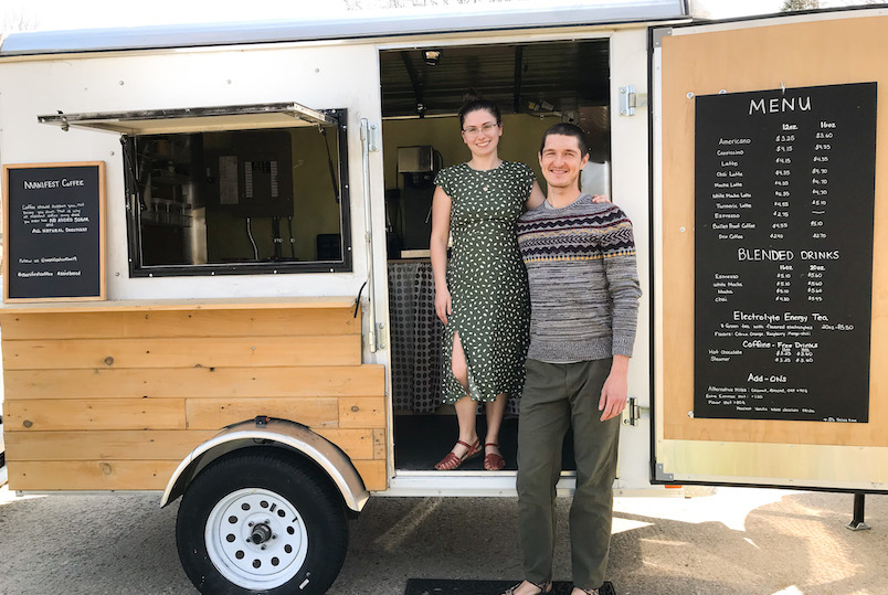 Man and woman standing in front of their coffee food truck by Manifest Coffee Catering in High Falls NY