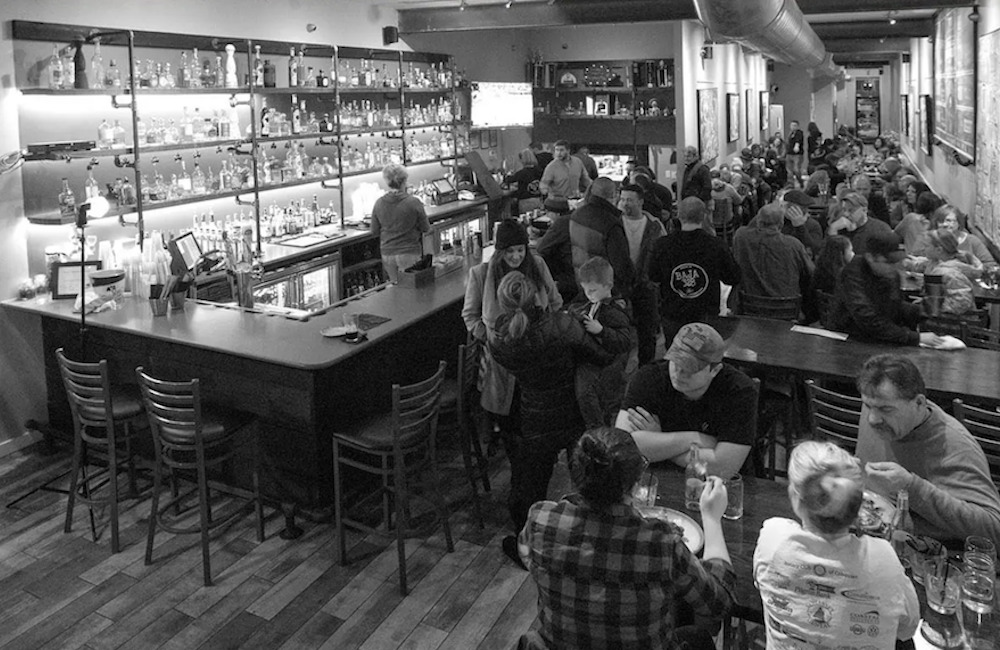 A B&W photo of customers hanging out at the bar Baja 328 in Beacon NY