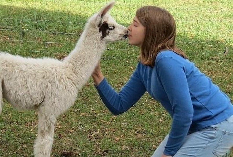 young girl kissing am animal at Clover Brook Farm in Hyde Park NY