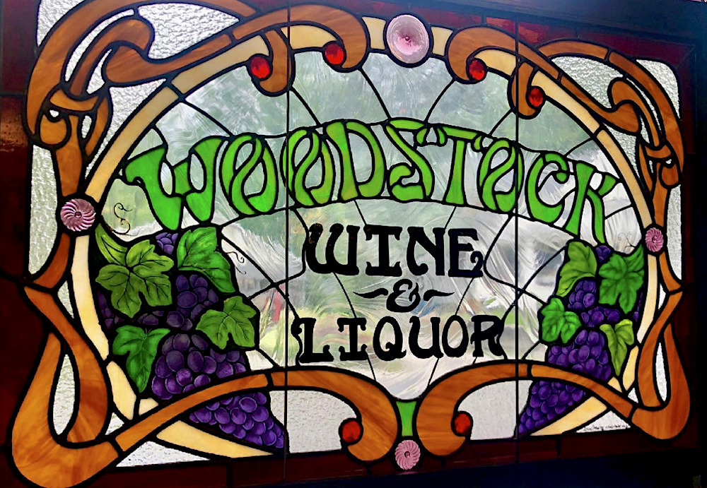 stained glass hanging sign in the window at Woodstock Wine & Liquors in Woodstock, NY