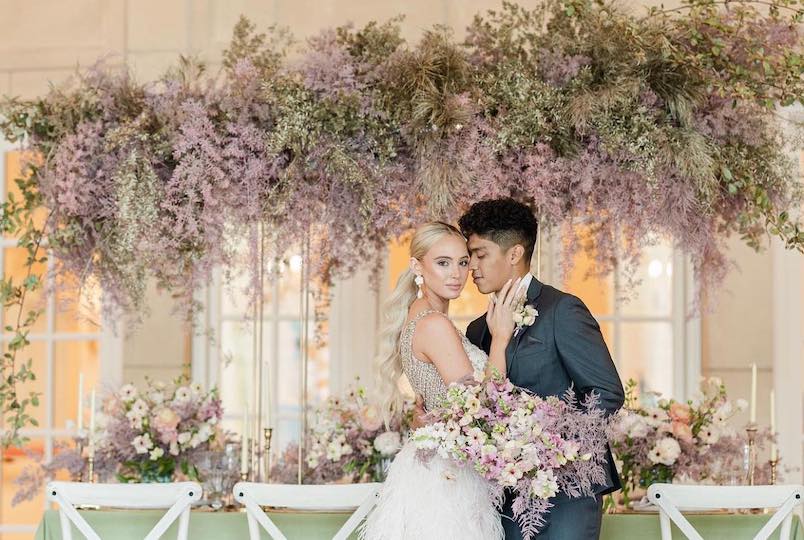 Wedding couple with extravagant floral arrangements by TK Floral Designs in Modena NY