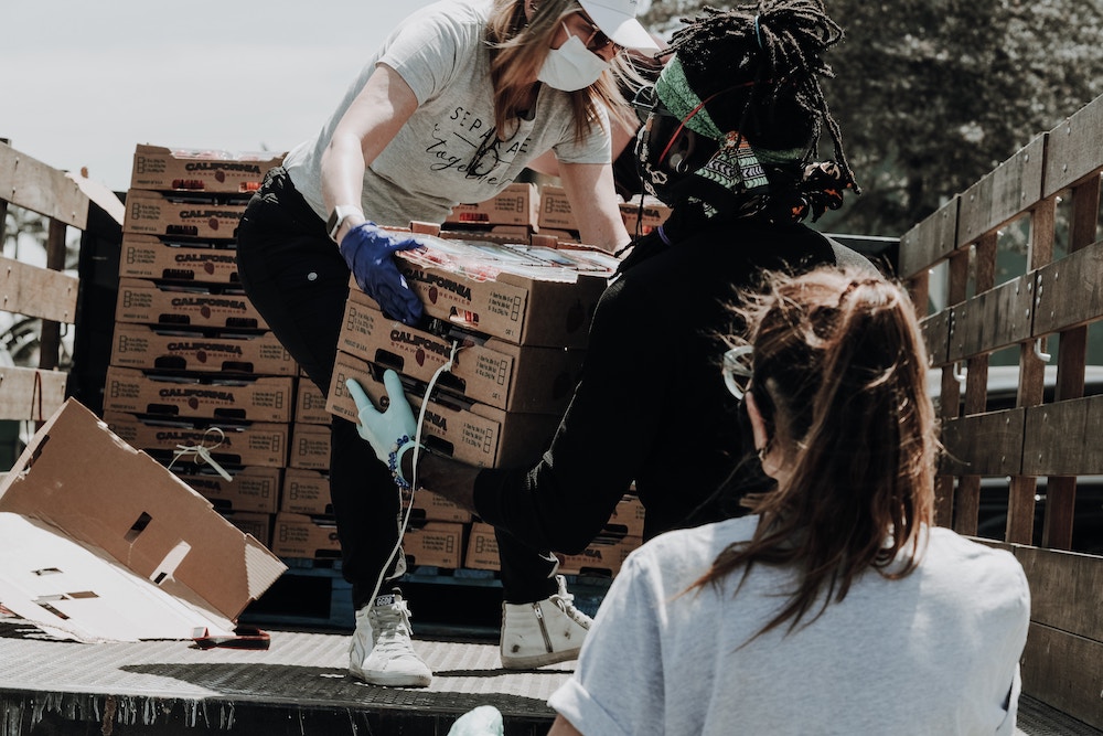 People moving food and supplies off a truck Community Building Through Volunteers blog by Jenny Wonderling and Inside+Out Upstate NY in the Hudson Valley